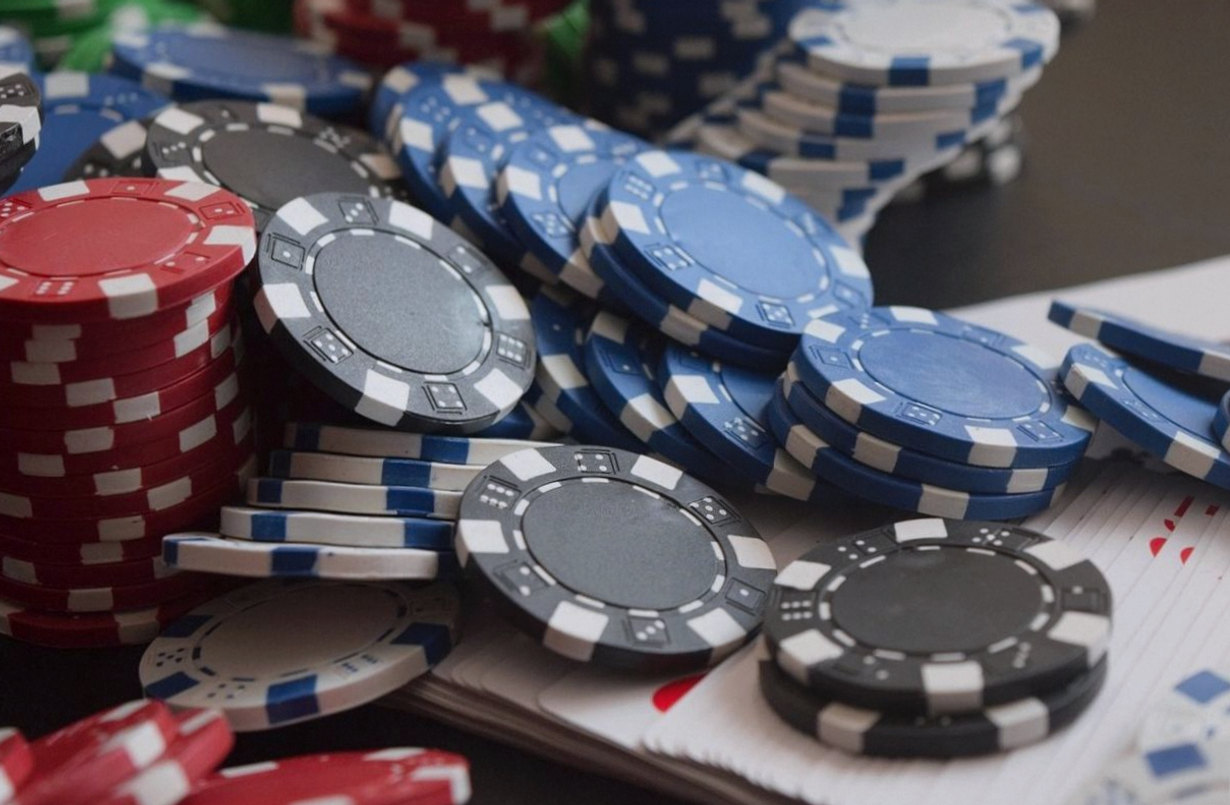Playing cards and casino chips arranged on a felt table